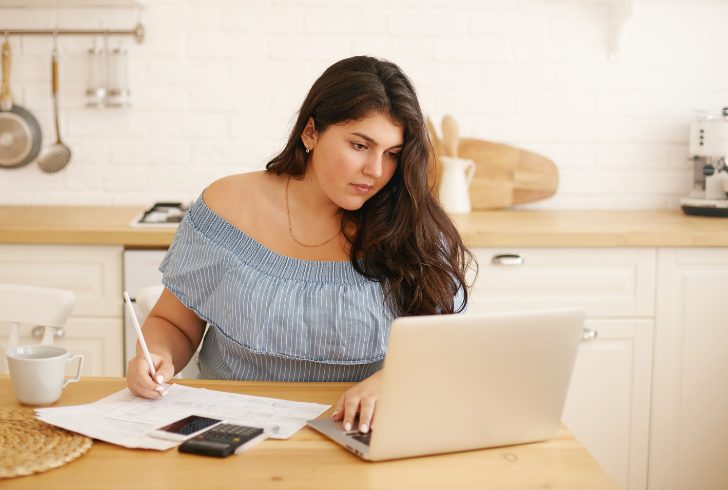 Person smiling while reviewing savings account