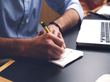 man writing down