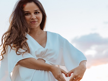 woman in white with baby bump