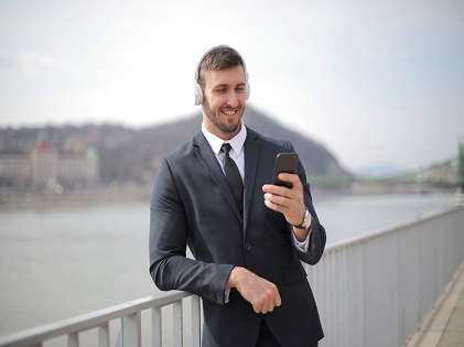 man-in-black-suit-jacket-holding-black-smartphone